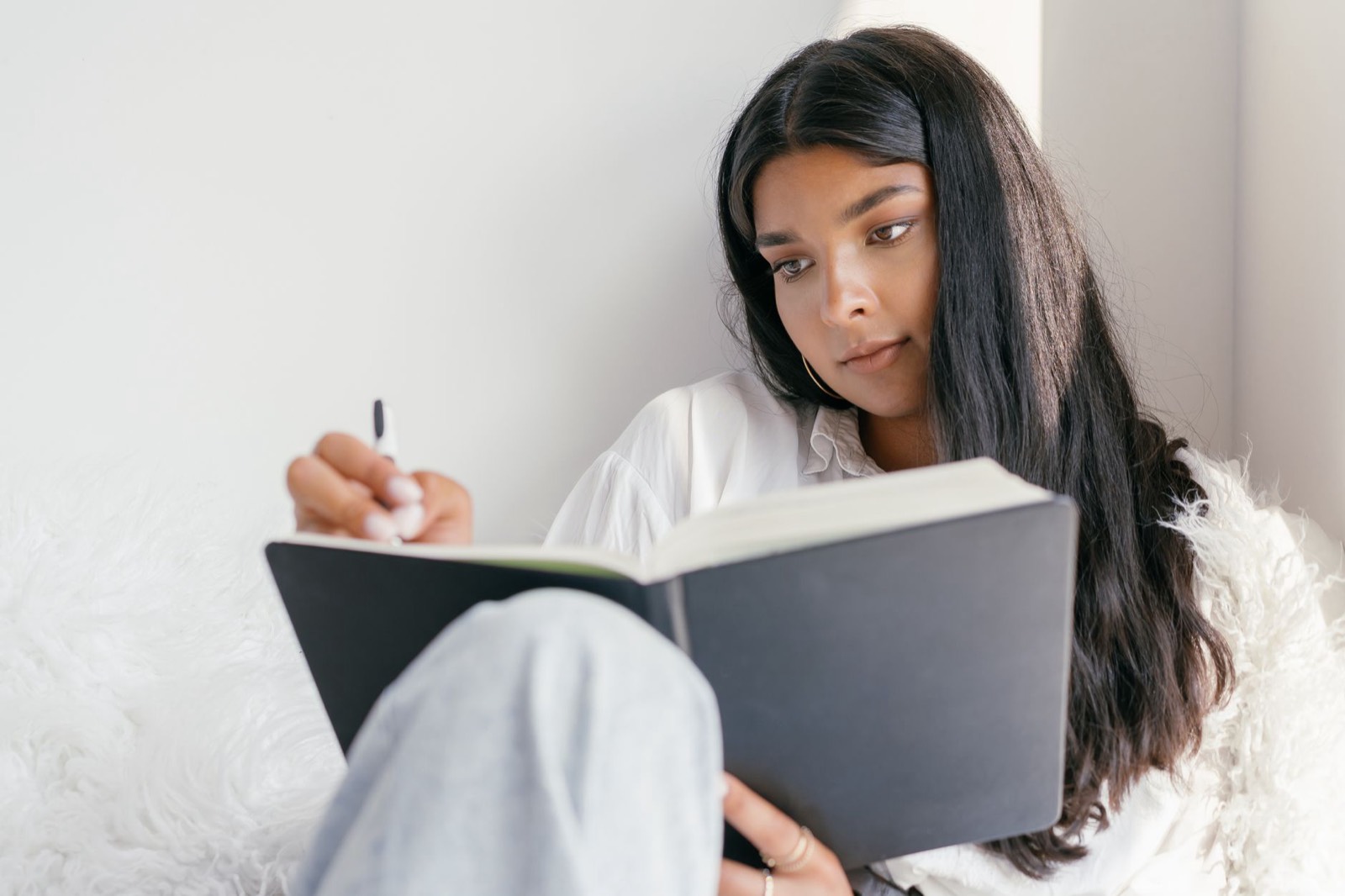 Personne seule qui écrit dans un carnet, dans une pièce calme